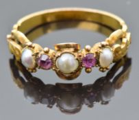 An early Victorian ring set with split pearls and foiled pink sapphires with engraved and pierced