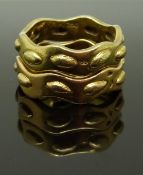 Two Cartier 18ct gold rings with raised oval decoration, size L/M, 13.48g