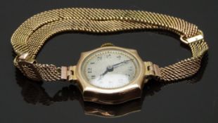 Swiss 9ct gold ladies wristwatch with blued hands, black Arabic numerals, silver dial and 15 jewel
