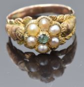 Victorian yellow metal ring set with an emerald and seed pearls with textured detail to the