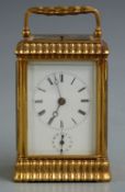 A 19thC gilt brass carriage clock with moulded decoration to corniche style case, the half hourly