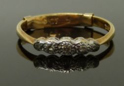 An 18ct gold ring set with five graduated diamonds in a platinum setting, size R, 2.68g