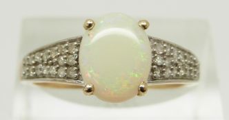 A 9ct gold ring set with an oval Ethiopian opal cabochon and diamonds, size R, 2.5g