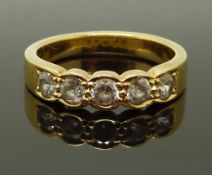 An 18ct gold ring set with five round cut cubic zirconia, size P, 6.18g