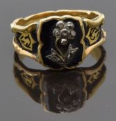 An early Victorian ring set with diamonds in the shape of a flower on black enamel ground, the
