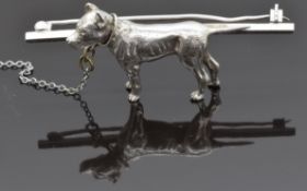 A silver brooch in the form of a Staffordshire bull terrier dog