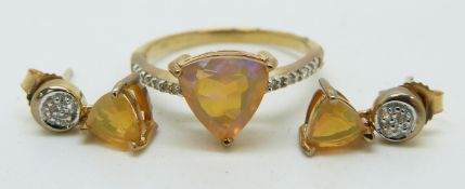 A 9ct gold ring set with a trilliant cut Indonesian opal and diamonds (size N) with a pair of