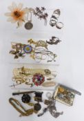 A collection of jewellery including Corocraft brooch, silver St Christopher, silver rings, cap