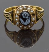 Victorian 15ct gold ring set with a carved flower surrounded by seed pearls, with enamel