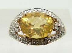 A 9ct gold ring set with an oval cut fire opal and diamonds, 2.8g, size N