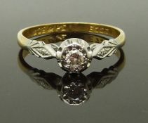 An 18ct gold ring set with a diamond in a platinum setting, 2.2g, size M