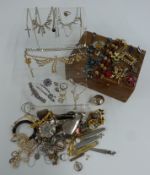 A collection of jewellery including diamanté, brooches, silver vesta, silver spoon, silver pendants,