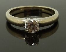 An 18ct white gold ring set with a round cut diamond of approximately 0.4ct, size O, 4.58g