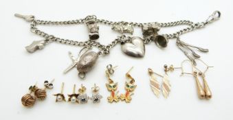 A silver charm bracelet with nine silver charms including gypsy caravan, heart pendant, etc and