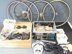 Large collection of bicycle components including four rear wheels, chain sets, Shimano derailleur