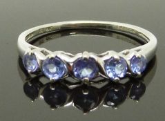 A 9ct white gold ring set with tanzanites, size N, 1.59g