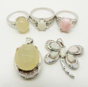 Two silver rings one set with a pink opal and the other a yellow opal, a silver pendant set with a