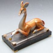 Art Deco style ceramic gazelle raised on a stepped base, marked to rear possibly Mangani, height