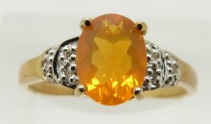 A 9ct gold ring set with an oval cut fire opal and diamonds, 1.7g, size N