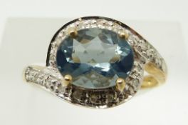 A 9ct gold ring set with an oval blue fire opal and diamonds, 2.2g, size N