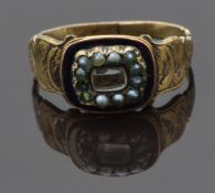 Victorian mourning ring set with hair in a central glass compartment, seed pearls and black