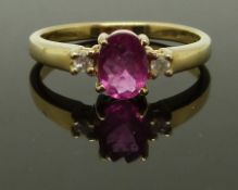 A 9ct gold ring set with an oval rubellite and two diamonds, size M, 2.42g