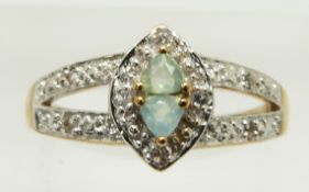 A 9ct gold ring set with two trilliant cut Paraiba opals and topaz, 2.8g, size N