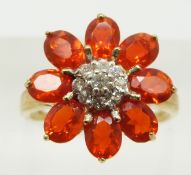 A 9ct gold ring set with eight oval cut Salamanca fire opals and white sapphires, 2.6g, size M