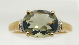A 9ct gold ring set with a green fire opal and diamonds, 1.9g, size N