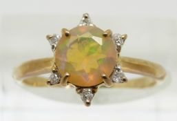 A 9ct gold ring set with a round cut opal surrounded by diamonds, 1.7g, size N