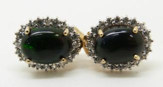A pair of 9ct gold earrings set with an oval cut Mezezo opal cabochon and zircons, 1.8g