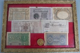 A collection of early 20thC German banknotes etc in frames, 34 x 49cm