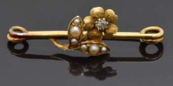 Edwardian 15ct gold brooch in the form of a flower set with a diamond to the centre and pearls to