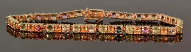 A 9ct gold tennis bracelet set with topaz and citrine, 19.5cm, 11.9g