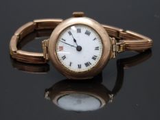 A 9ct gold ladies wristwatch with blued hands, Roman numerals, white enamel dial and unsigned