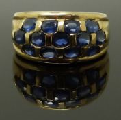 A 9ct gold ring set with oval cut sapphires, size M/N, 4.90g
