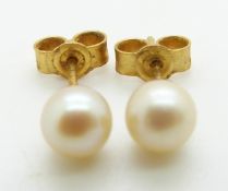 A pair of 9ct gold earrings set with a pearl to each