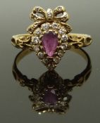A 9ct gold ring set with a pear cut ruby and diamonds, size L/M, 2.35g
