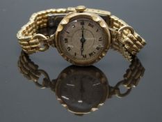 Swiss 9ct gold ladies wristwatch with blued hands, black Roman numerals, silver dial, gilt minute