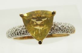 A 9ct gold ring set with a trilliant cut fire opal and diamonds, 2.3g, size N