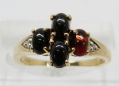 A 9ct gold ring set with four oval Mezezo opal cabochons and diamonds, 2.6g, size N