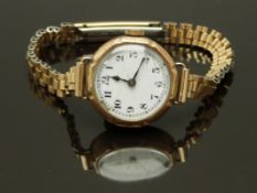 Swiss 9ct gold ladies wristwatch with blued hands, black Arabic numerals, white enamel dial and
