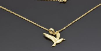A 14k gold pendant depicting a dove (1.4g) on a 10k gold chain (0.6g)