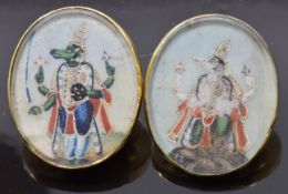 Two 19thC Indian yellow metal buttons set with ivory painted panels depicting wolf gods, 3 x 2.5cm