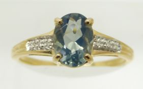 A 9ct gold ring set with an oval blue fire opal and diamonds, 1.6g, size N
