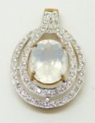 A 9ct gold ring set with an oval cut ice opal surrounded by topaz, 3.3g