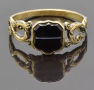 Victorian ring set with a cartouche shaped section of banded agate and with pierced foliate