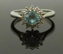 An 18ct white gold ring set with a round cut zircon surrounded by diamonds, 3.9g, size J/K