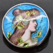 Art Nouveau silver brooch set with enamel depicting a young woman, signed to back, 2.2cm diameter