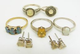 A silver ring set with three opal doublets, two silver rings set with an opal and marcasite, a
